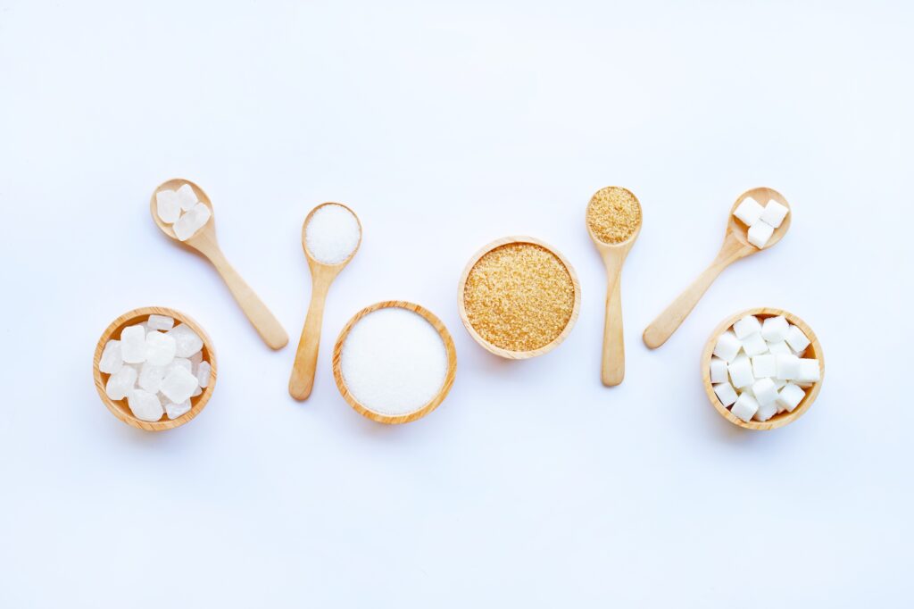 different types of sugar on white background