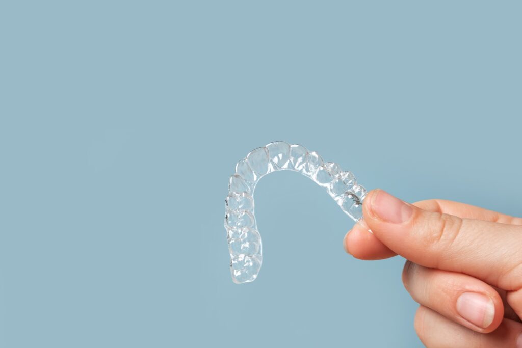 hand holding clean clear aligner