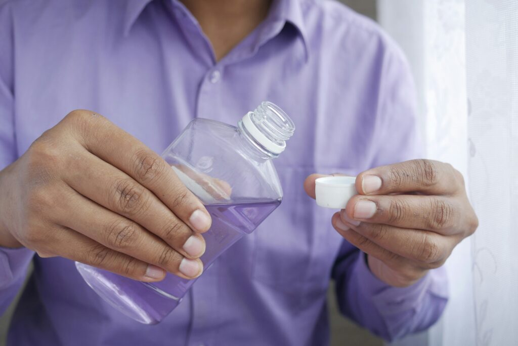 Man using mouthwash